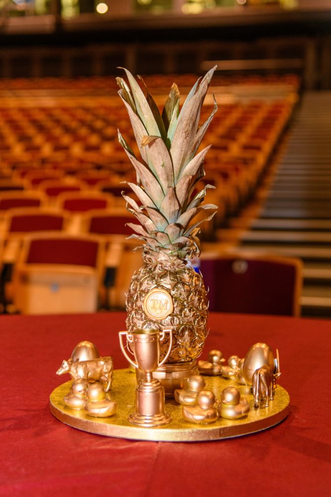 Pineapple table decoration - gold pineapple and other gold Taskmaster items, like cows and ducks.