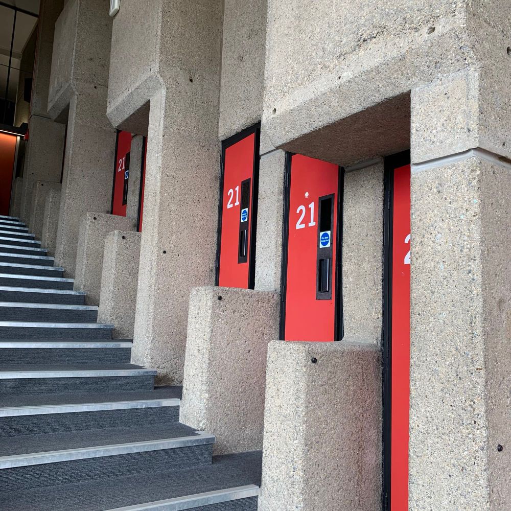 Four narrow red doors, all numbered “21”