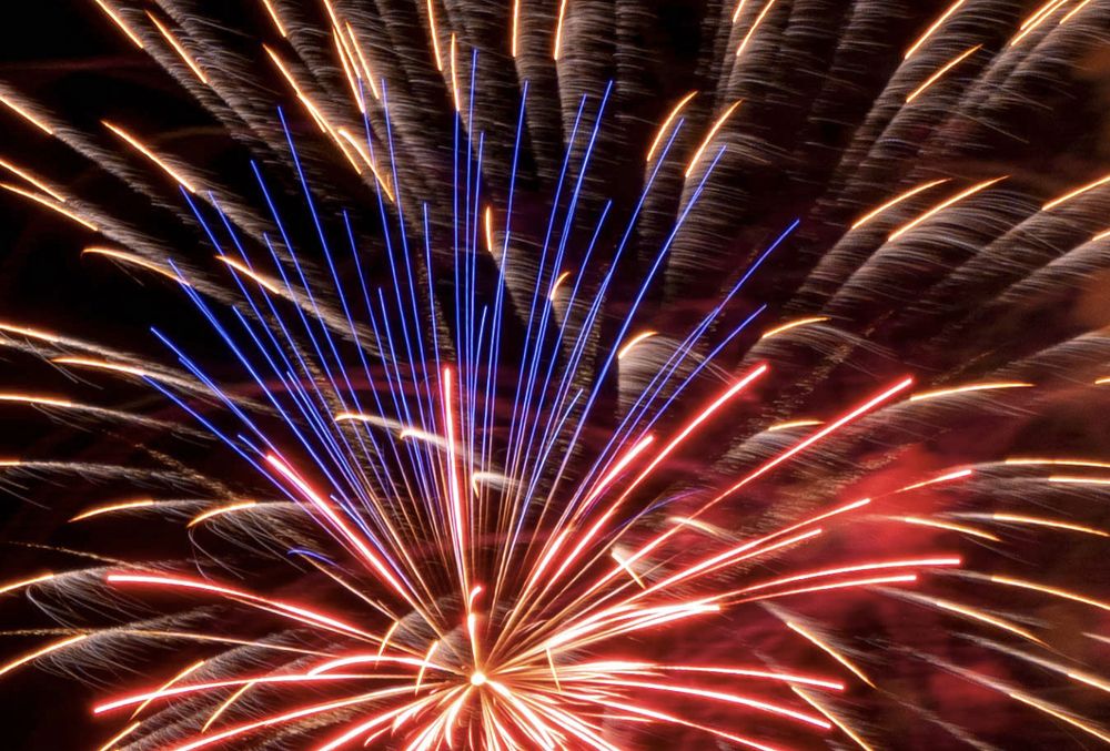 Closeup picture of commercial fireworks exploding in the sky