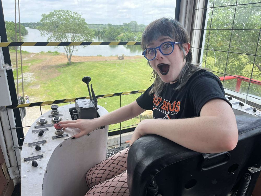 Eden pretending to press a button on Brutus' control panel