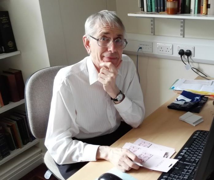 Photo of Professor Malcolm Heath at his desk at the University of Leeds