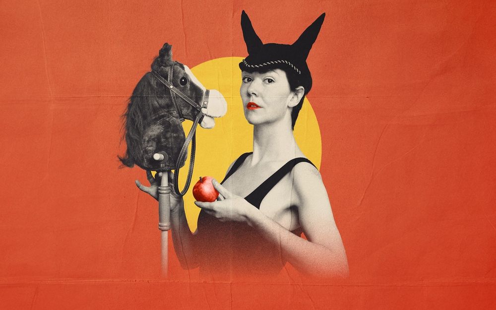 Promotional image of Ely Lyons wearing horse ears, holding a horse head toy and an apple
