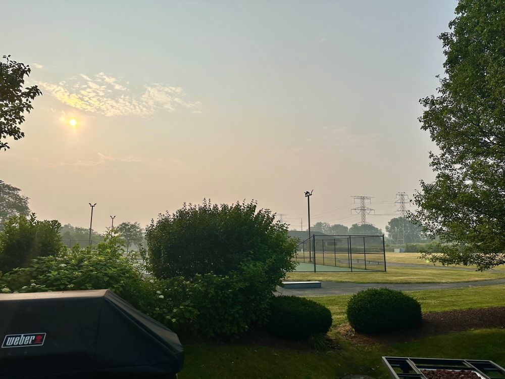 Slightly hazy morning sky picture with a halo around the sun 