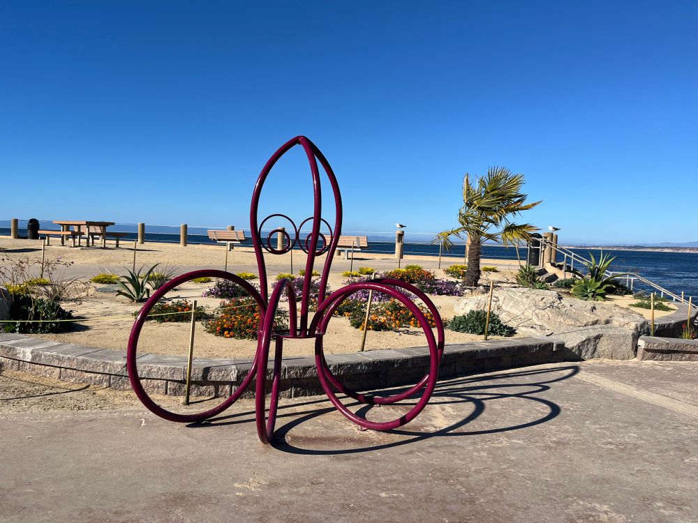 An octopus-shaped bike rack on the beach