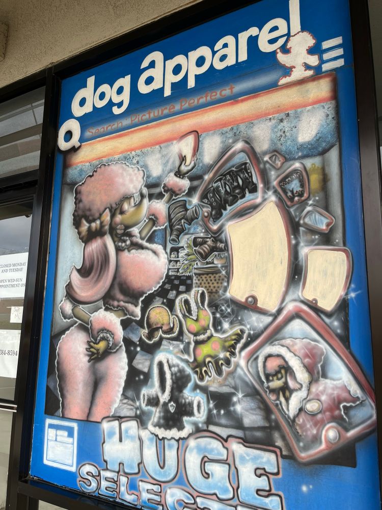 A hand painted elaborately styled airbrush portrait of a feminine poodle dog in a pink outfit on a shopping spree with the words “DOG APPAREL HUGE SELECTION”