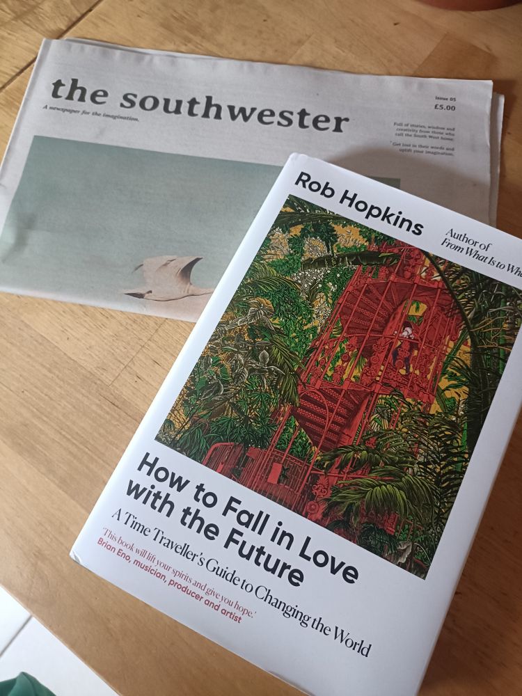 The southwestern newspaper 'for the imagination, full of stories, wisdom and creativity from those who call the south west home' sits underneath Rob Hopkins' new book, How to Fall in Love with the Future 