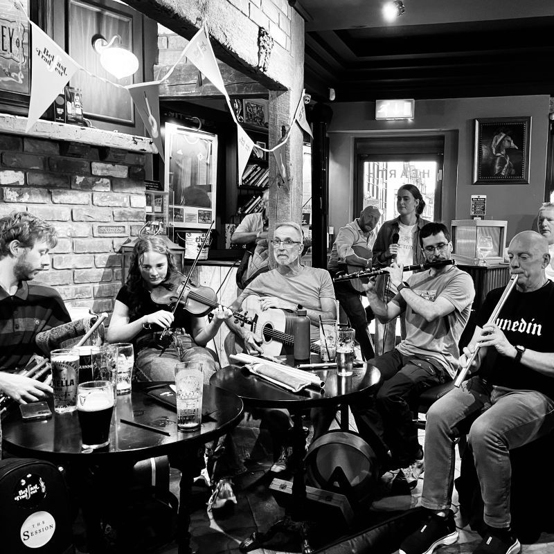 Pipes, fiddle, guitar, and flutes in a pub.