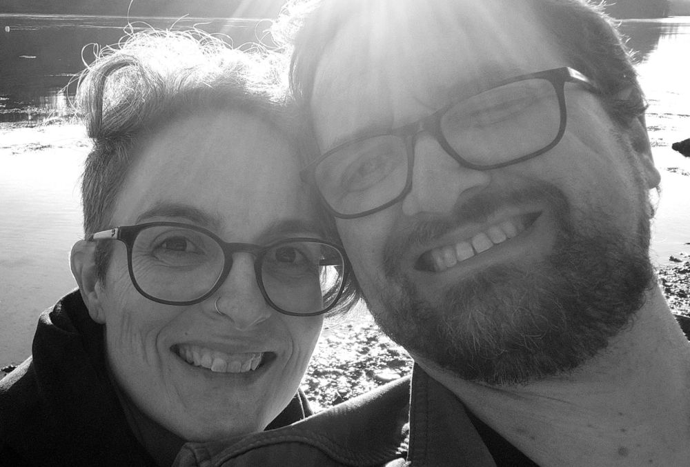 A woman and a man smiling at the camera.