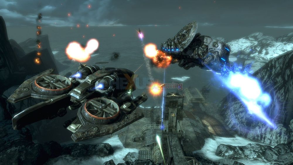 Downward look between two futuristic, flying or floating vehicles shooting at-, and being shot from the surface. The futuristic weapon blasts are an electric blue, a sickly pea green, and a pinkish orange colour.