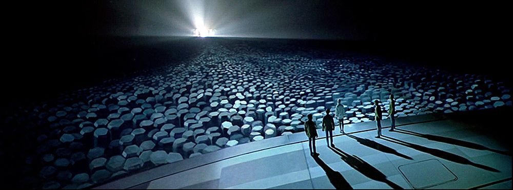 Kirk, Spock, and McCoy stand on the lip of the Enterprise's saucer in a a scene from Star Trek: The Motion Picture