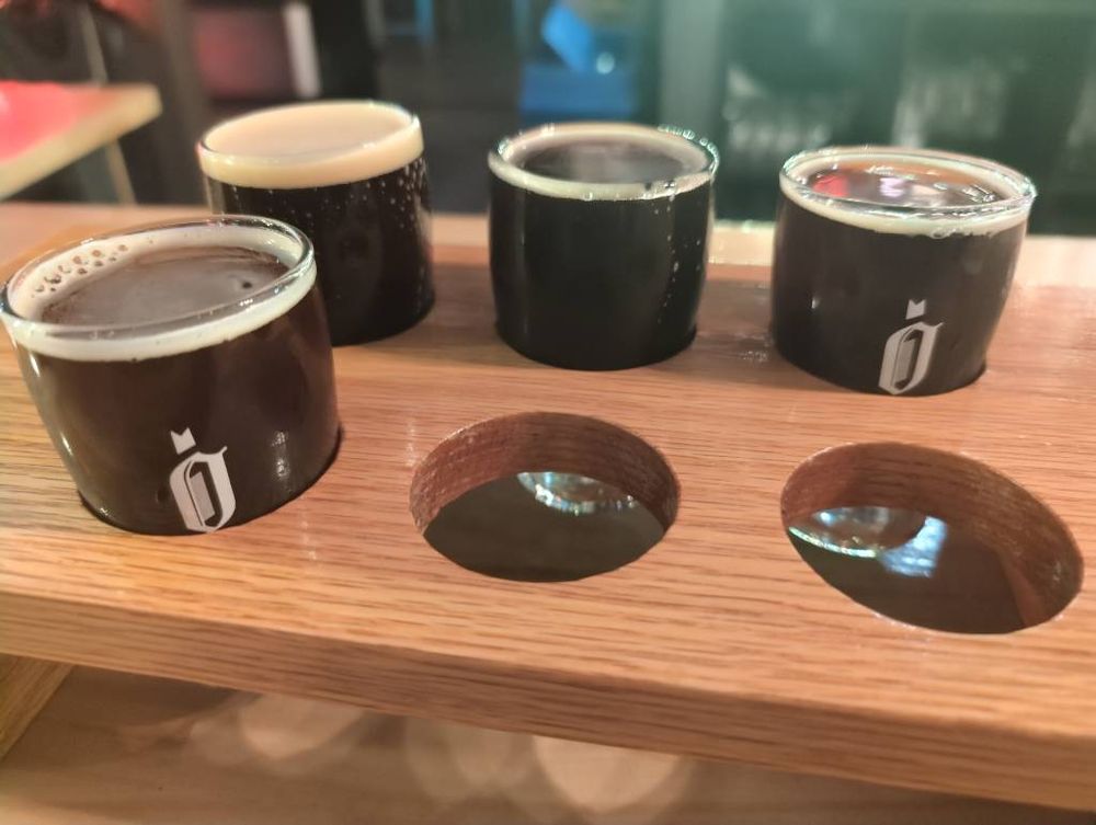 A taster rack of four Obec Brewing Belgian quad beers, from the past four years.