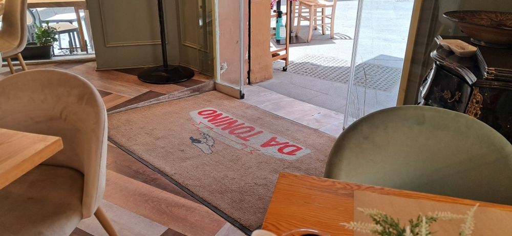 Restaurant in historic old town in Spain offers solution to overcome the old step up from the street outside problem with a gentle slope ramp inside the entry door.