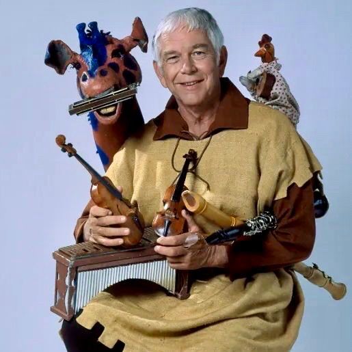 A publicity photo of the cast of the CBC Television show The Friendly Giant. Jerome is a giraffe and Rusty is a chicken. 