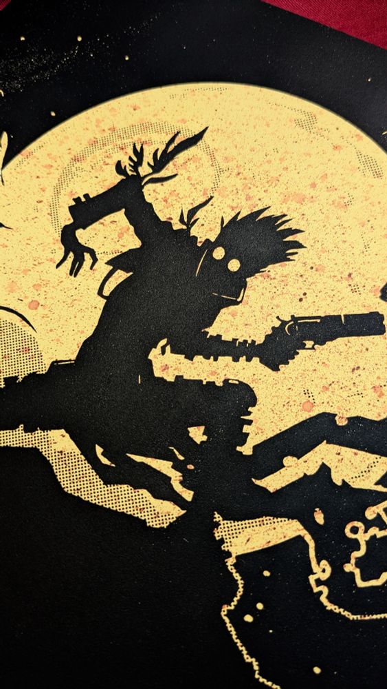 Close up of a different ink splatter on a print of the same design
