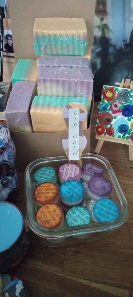 Homemade soap in a brown cardboard box
Lip balm in a glass jar 