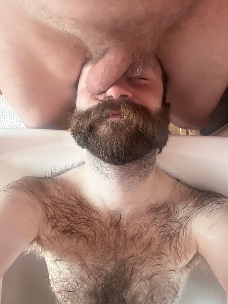 Me in the bath with a fat dick on my face.