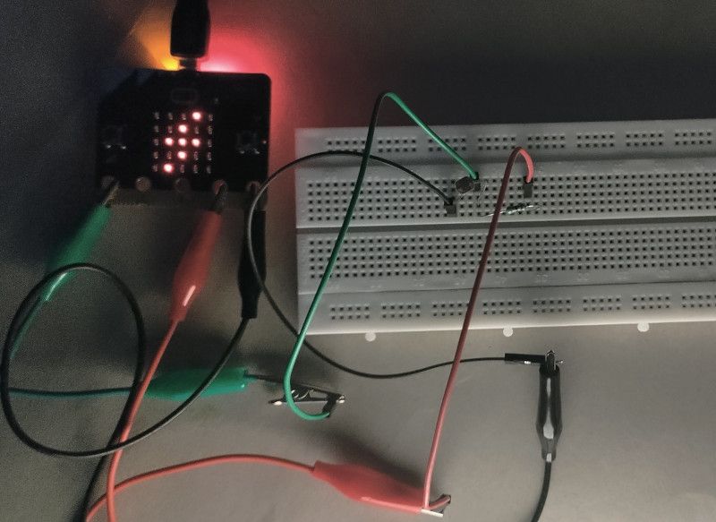 Voltage emoji being shown in microbit led matrix in dark room 