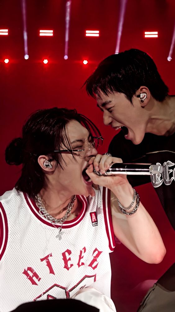 kpop group ateez members song mingi and choi san photographed mid-performance 