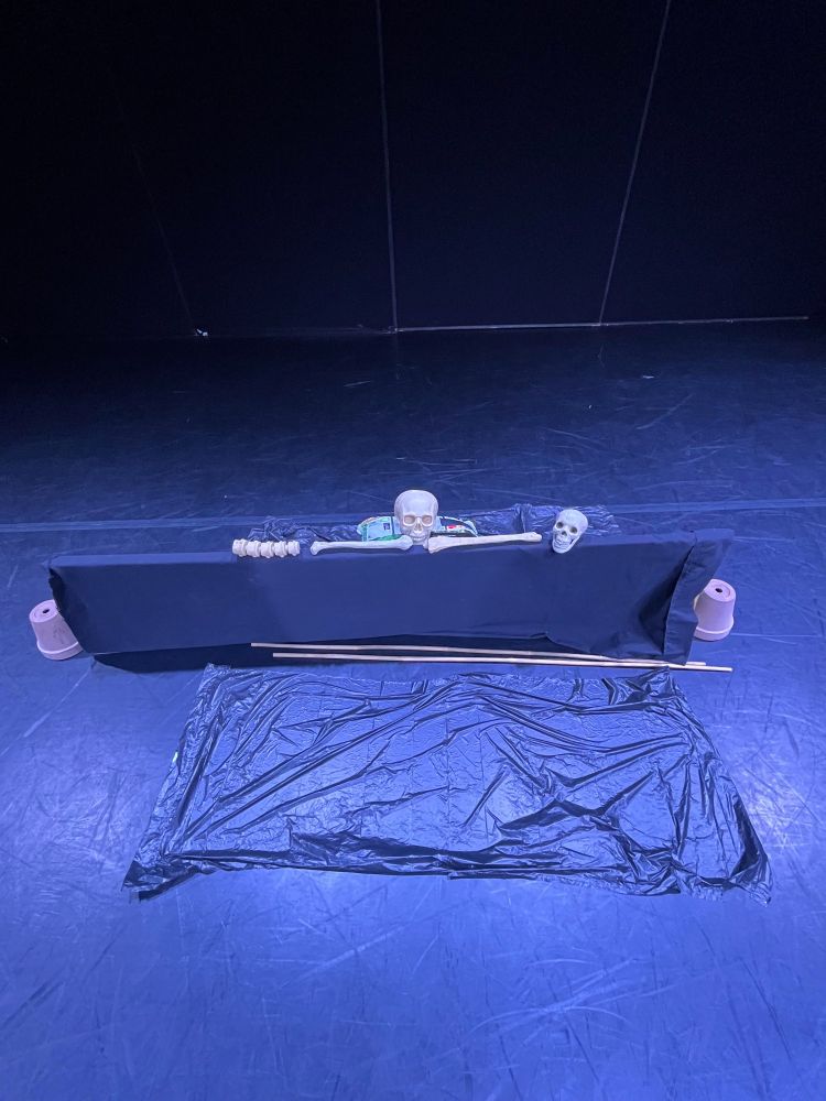 Prop skulls and bones in the graveyard setting for Alas! Poor Yorick.