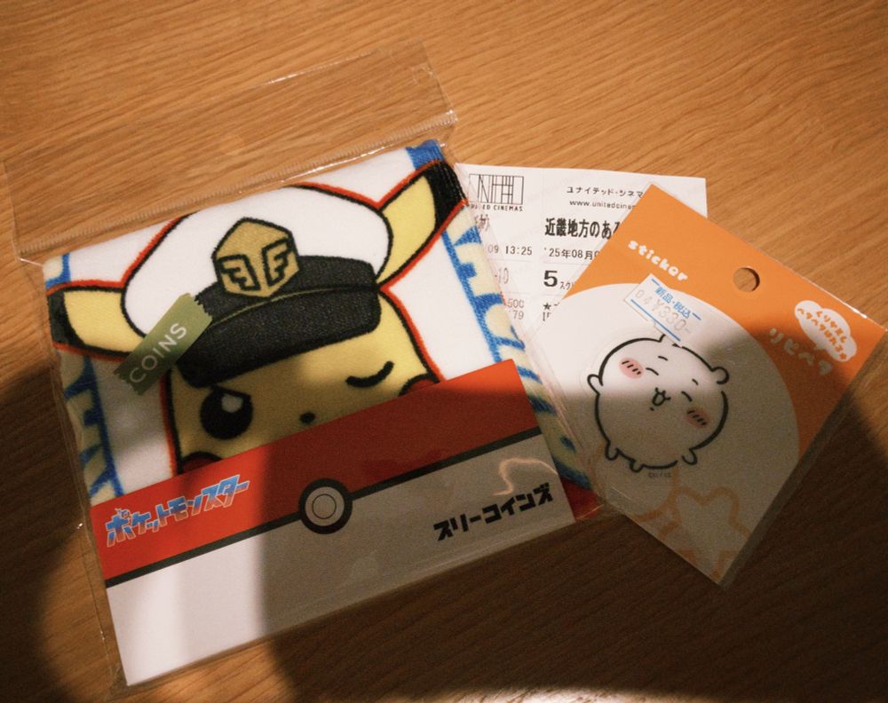 テーブルの上に並んだグッズ
左からタオルハンカチ、映画の半券、ステッカー