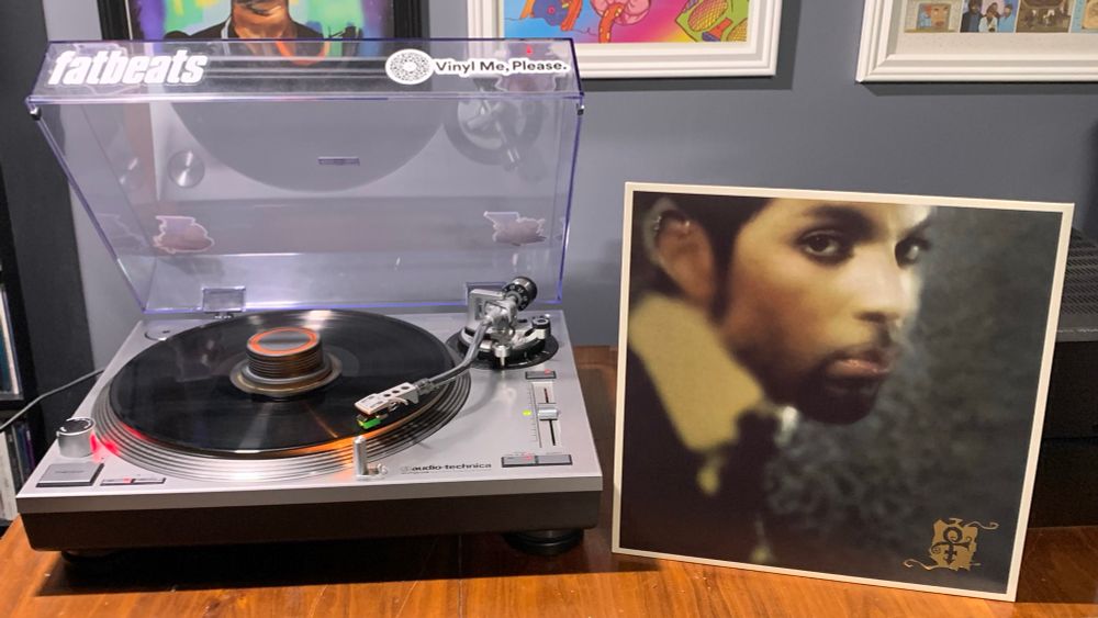 a vinyl pressing of “The Truth” by Prince playing on a turntable with the album cover propped up to its right