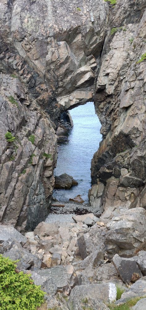 A natural stone arch looking out into the sea