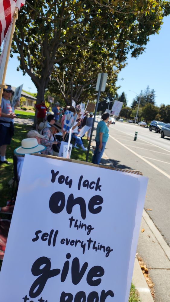 Protestors sign: you lack one thing sell everything and give to the poor