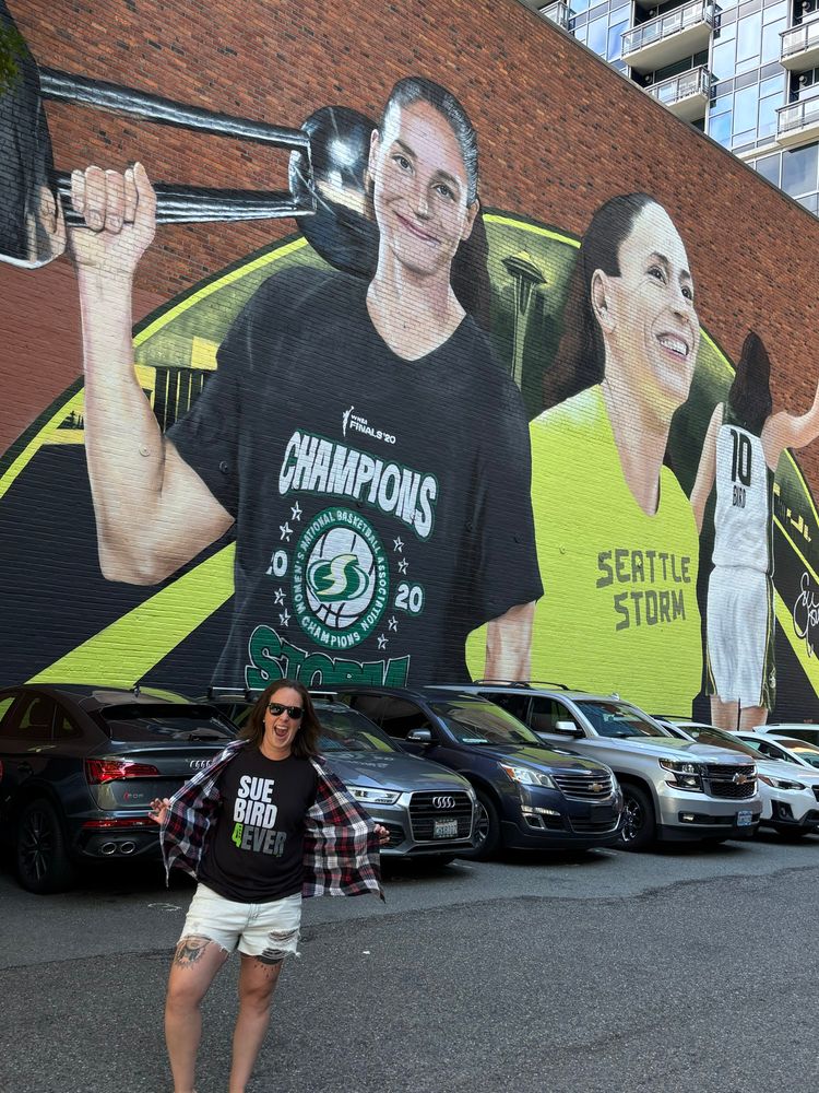 Michaela in front of the Sue Bird mural. 