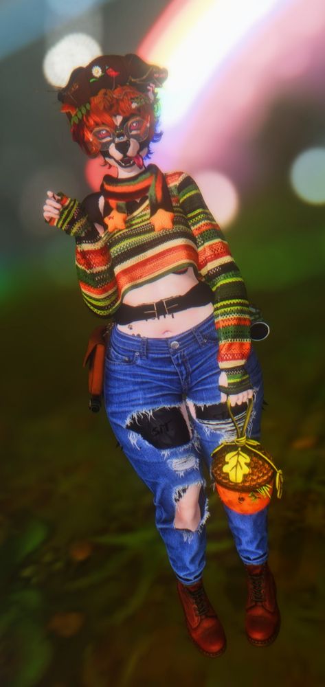 melody standing on grass in jeans and brown boots holding a acorn purse and waistbelt with sachel. Top is striped knit top with greens and orange reds hues. scarf has same hues and stars at end of it. beret hat and red neurospicy pin at top and twigs and branches and leaves sticking out of brown short hair. background blurred but has a rainbow in distance.