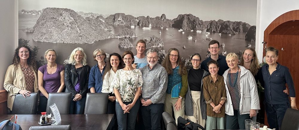 The group of participants smiles at the camera after a successful workshop day.