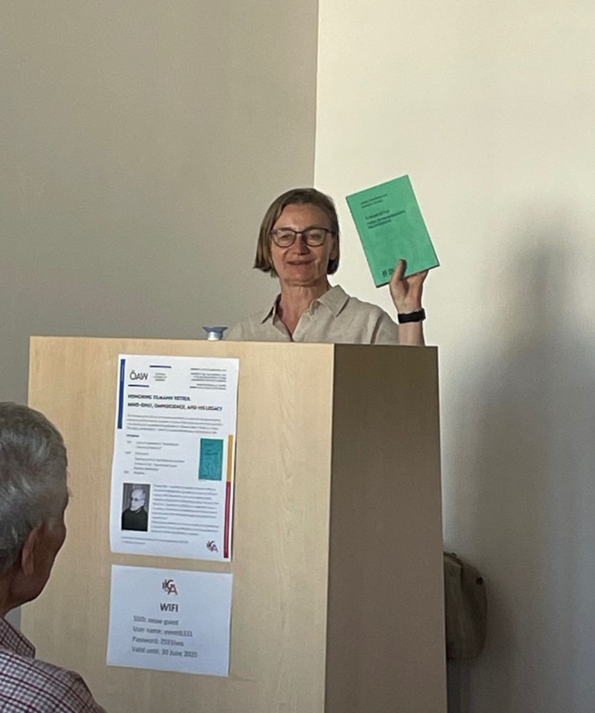 A professor shows a book