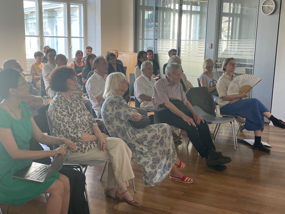 A group of people listening to a lecture