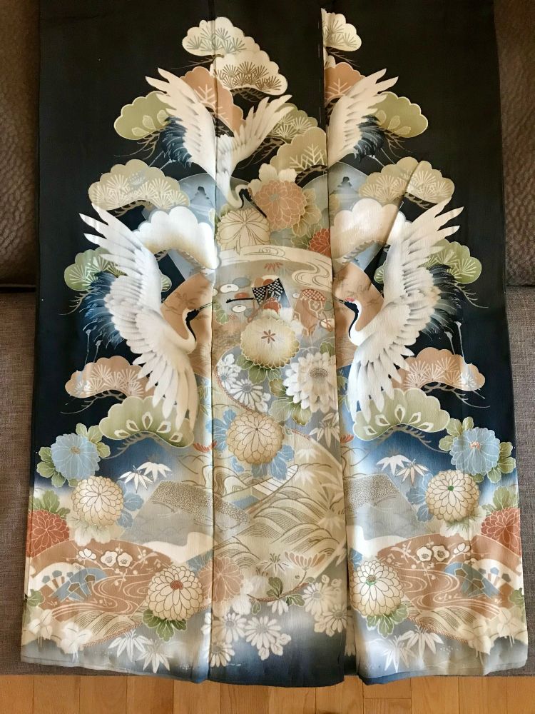 Kimono design of cranes, flowers and landscape on a black background 