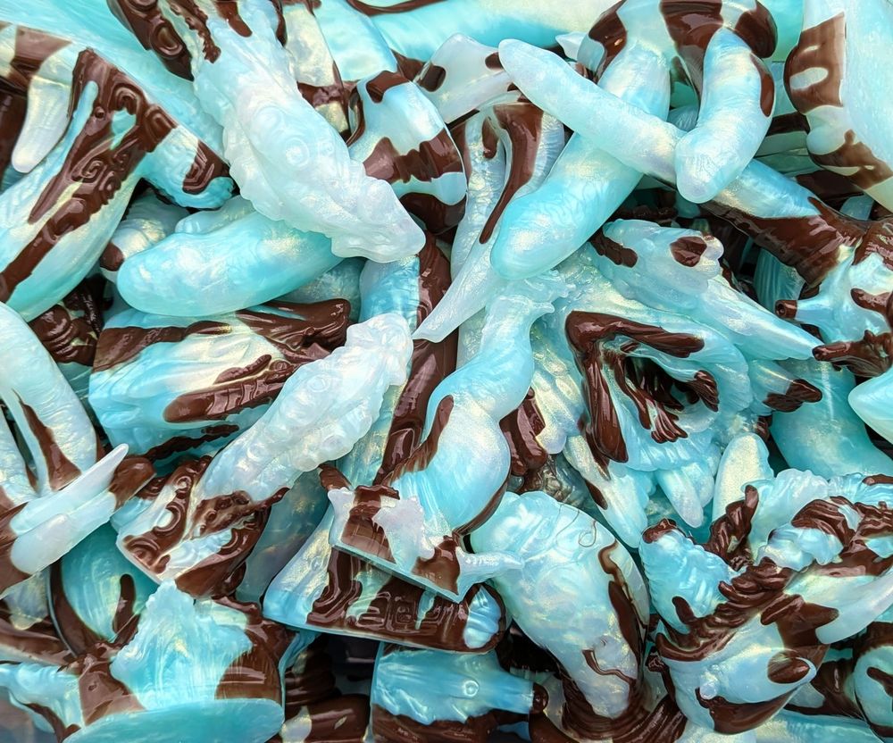 a pile of sparkly mint chip ice cream colored sex toys