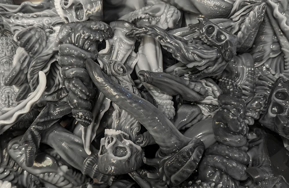 a pile of xenomorph colored silicone dildos