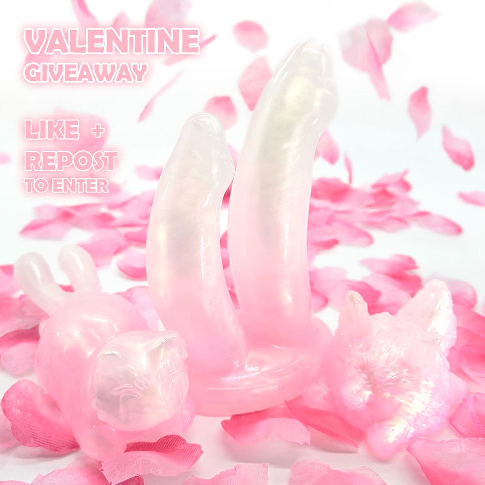 a pink dildo, squishy cat, and wolf on a white background with pink rose petals