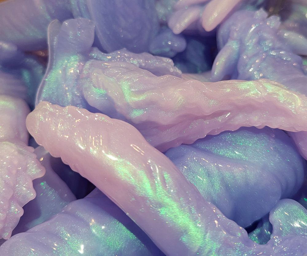 a pile of lilac purple silicone fantasy dildos