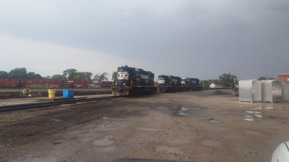 A pair of high hood GP38-2's in front of an SD40-2 in Norfolk Southern livery