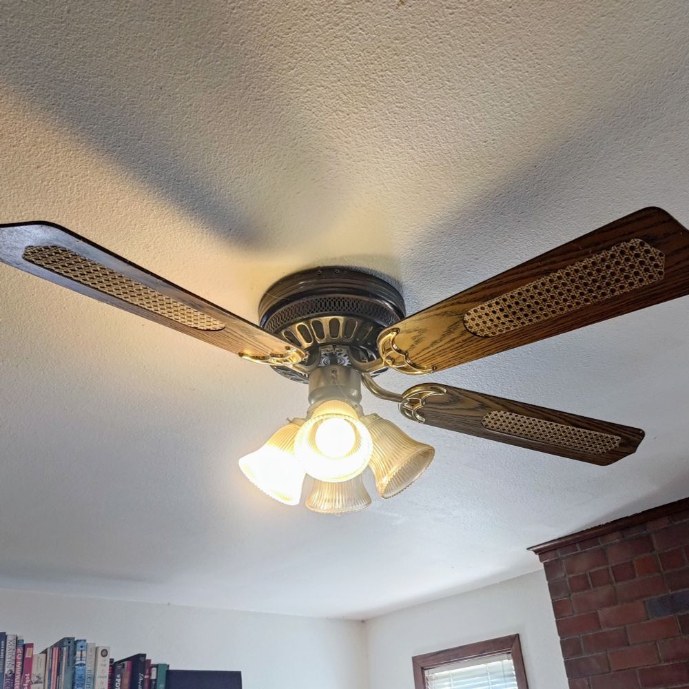 old-fashioned ceiling fan with two missing blades and two lamps out