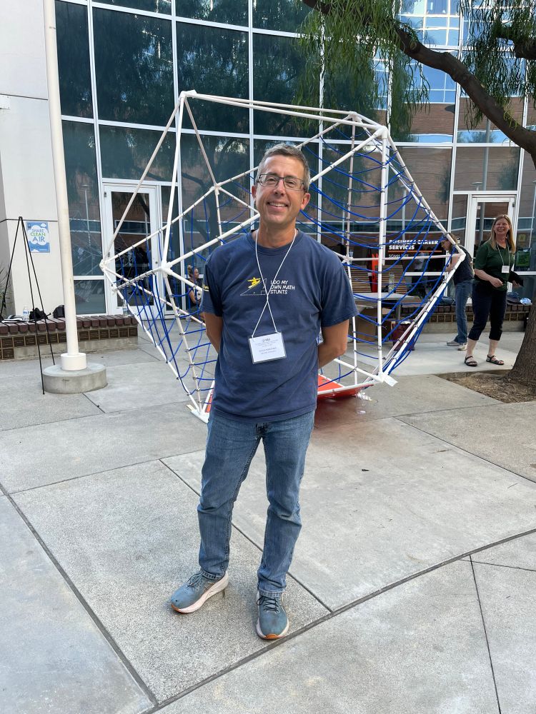 Glen Whitney standing in front of the giant icosahedron