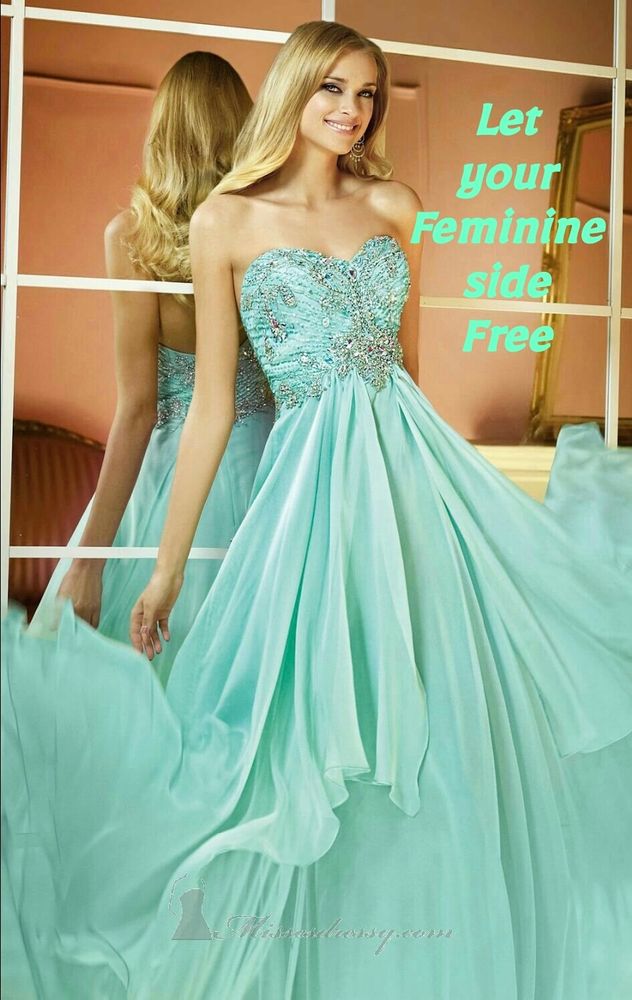 A sissy in a flowing, strapless, light blue gown with intricate beadwork, standing next to a mirror. Text on the image reads, "Let your Feminine side Free."