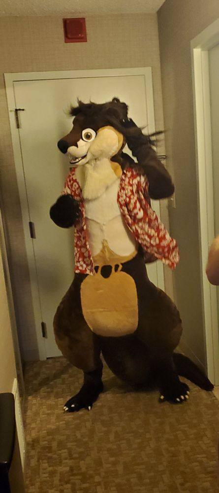 Otter fursuit flipping hair in mirror