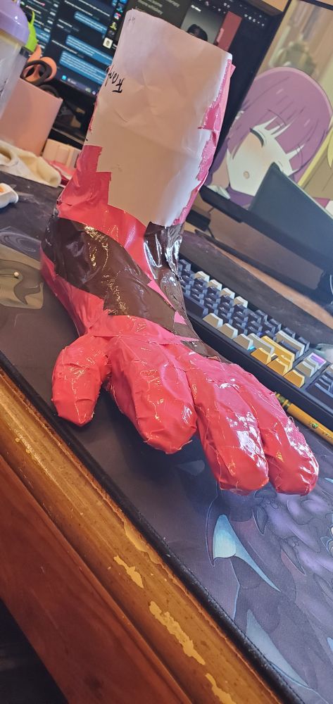 Otter fursuit toes taped up facing the digits more head on