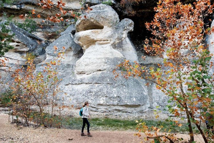 A hiker (from TripAdvisor, sorry!) in front of the monkey shaped rock I'm describing in the text. She is smartly dressed for a Fall hike, and the color is just showing in the trees.