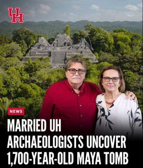 It's a headline that says "Married UH Archaeologists uncover 1,700 year old maya tomb".  The two of them look like a nice Midwestern married couple in their 60's.  The man wears a red button-up shirt, the woman a nice white blouse with a sort of black leaf-pattern or silk-screen on it.  Behind them is a Mayan temple on a heavily forested hill.