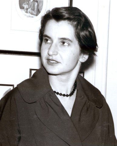 With all she did to make Watson and Crick's discovery possible, Rosalind Franklin was essentially "a de facto collaborator," says Lynne Osman Elkin.
Novartis Foundation

Dr. Franklin looks to her right, wearing a dark necklace and broad-yoked shirt or blouse.  She has short dark hair and eyebrows, and has a look of sharp intelligence, with an edge of weariness.