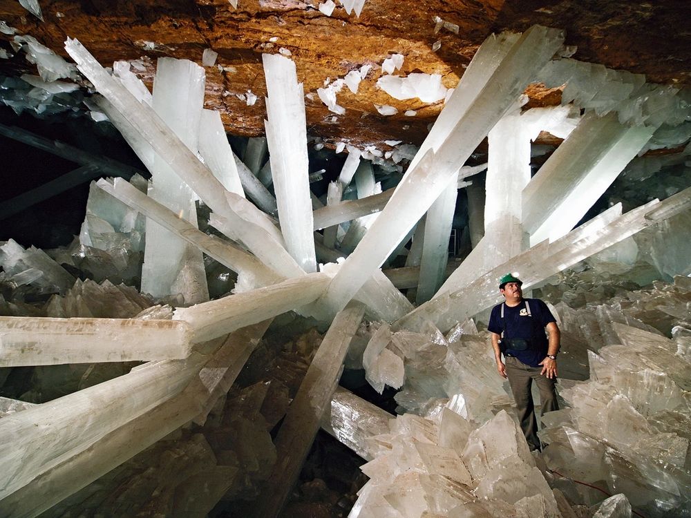 A man stands in a cave filled with white crystals, many of them much taller and larger than he is.  The scale is hard to even understand.

CREDIT:  Javier Trueba

From the C&EN article I'm citing below:
"For millennia, conditions within the Cave of Crystals (290 m underground) were perfect for the growth of gypsum crystals, allowing them to grow to their massive size.  Credit: Javier Trueba/MSF/Science Source"