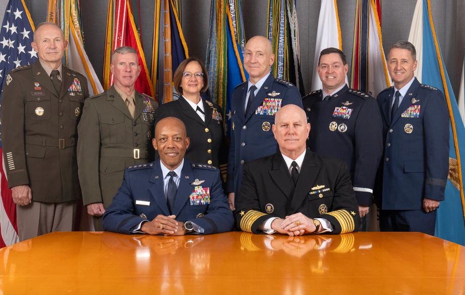 A picture of the Joint Chiefs, in full uniform in front of flags representing the military services.