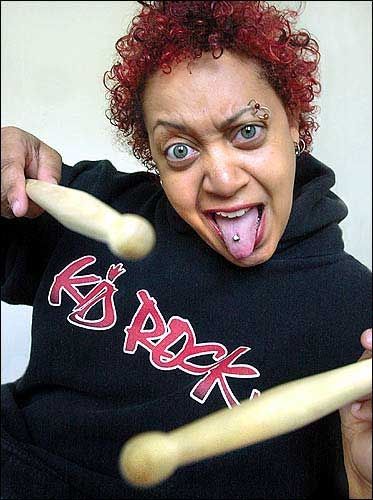 A photo of Stefanie Eulinberg, Kid Rock's drummer, with dyed hair and many facial piercings 