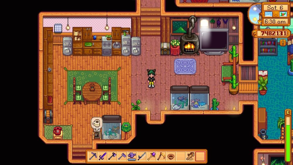 screenshot of my house in Stardew Valley. spacious kitchen with 3 refrigerators and a woodburning stove burning next to my 82' flatscreen